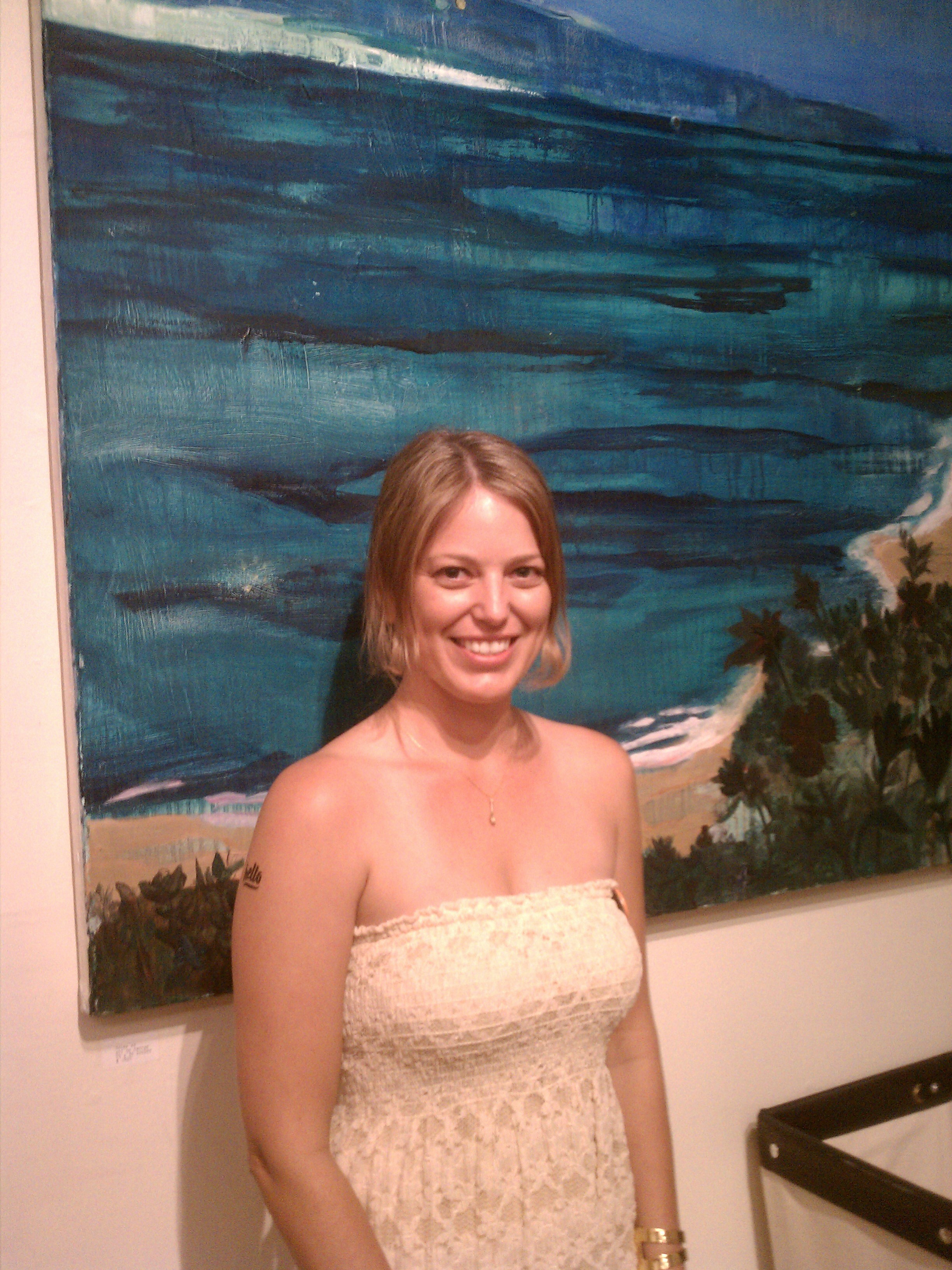 Celina Burns, one of the store's partners, stands in front of her beautiful oil painting “Isles xx.” 