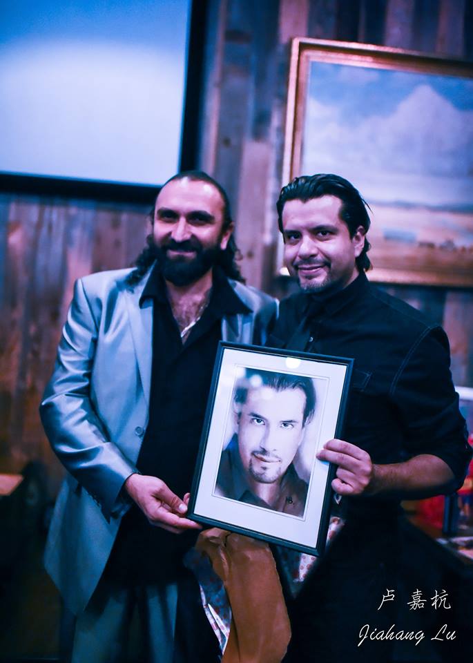 Acclaimed artist and actor Hovhannes  Babakhanyan presents his lifelike portrait of Joss Gomez. Photo courtesy of Jiahang Lu
