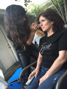Badri applying makeup behind the scenes backstage