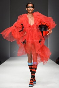 Red hot biker babe...model heats up runway in a fiery red ensemble with matching helmet. Photo courtesy of Ken Alcazar