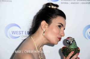 Vida puckers up to a crystal embellished minaudiere Paulo the Parrot clutch by Judith Leiber. Photo courtesy of Albert L. Ortega/GettyImages.