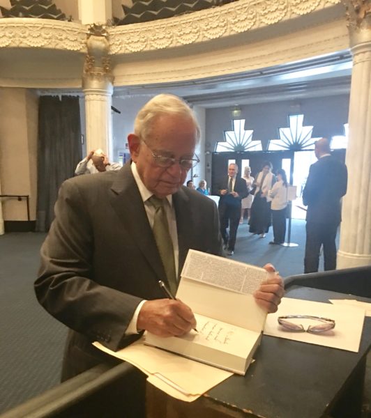Leo Melamed signing his book before Yom Kippur services at a the Saban Theatre